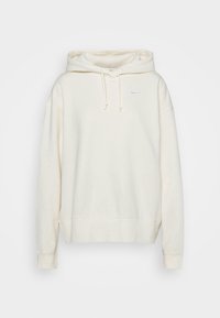 Felpa con cappuccio color crema dal taglio relaxed, con coulisse al collo, polsini a costine e un piccolo logo Nike azzurro chiaro sul petto.