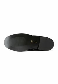 Black shoe sole with a textured rubber surface, featuring horizontal grooves and embossed sizing details. Smooth edges and rounded shape.