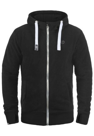 Black fleece hoodie with a full zipper, white drawstrings, side pockets, ribbed cuffs, and a subtle logo on the chest. Soft texture.
