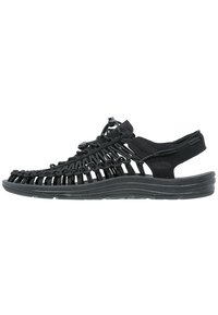 Black sandal with woven synthetic upper, adjustable lace closure, and a cushioned sole. Features open design for breathability.