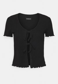 Top de punto negro con canalé, cuello redondo, mangas cortas y lazos ajustables en la parte delantera. Presenta un corte cropped y acentos con dobladillo en forma de ondas.