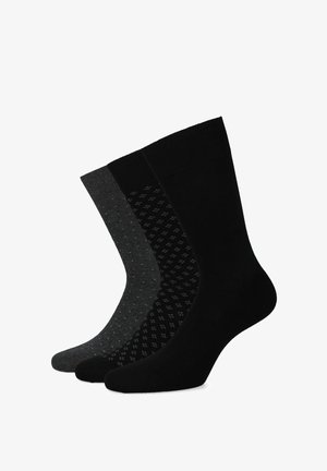 Trzy pary skarpetek: jedne w głębokiej czerni, drugie w ciemnoszarym z jasnoniebieskimi kropkami, a trzecie czarne z fakturowanym wzorem. Wszystkie mają średniej długości mankiety i gładkie wykończenie.