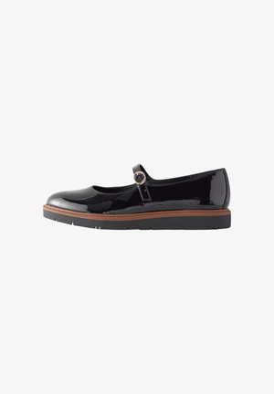 Chaussure Mary Jane en cuir verni noir avec une bride à boucle unique et une semelle marron avec une bande de roulement noire.