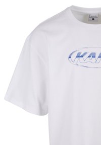 White cotton t-shirt with a round neckline, featuring a blue graphic "KAR" logo on the front. Short sleeves; smooth texture.