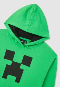 Felpa verde con cappuccio con design di un volto pixelato nero che somiglia a un personaggio Creeper di Minecraft sulla parte anteriore.