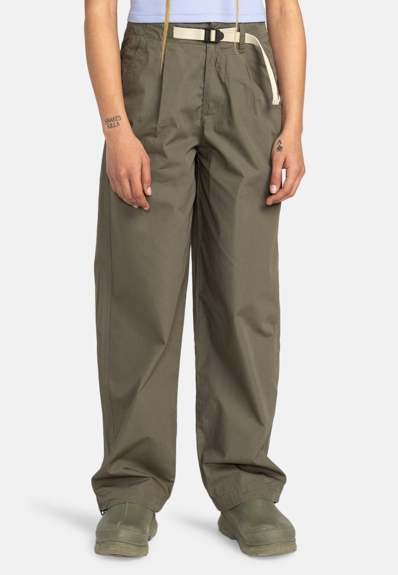 Cargo pants in olive green, featuring a relaxed fit, adjustable waist with a white belt, and reinforced stitching. Paired with green footwear.