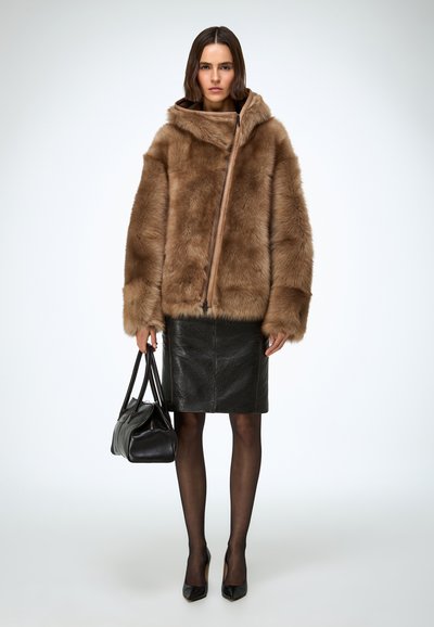 Faux fur brown jacket with a hood, front zipper closure; paired with a black leather pencil skirt and black high-heeled shoes.