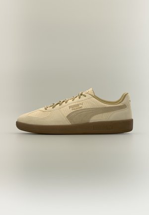 Beiger Puma Palermo Sneaker mit Wildleder-Textur, brauner Sohle und Puma-Logo an der Seite und Sohle, seitlich auf neutralem Hintergrund gezeigt.