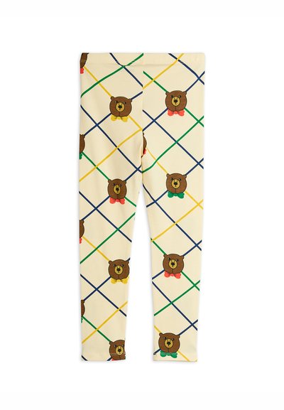 Leggings hechos de una tela ligera y elástica con un fondo crema adornado con caras de ositos de dibujos animados y patrones de diamantes coloridos en verde, amarillo y azul.