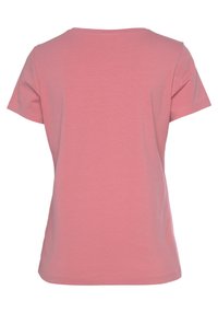 Camiseta de manga corta en algodón rosa claro, con cuello redondo, textura suave, forma ajustada, con una parte posterior lisa sin adornos.