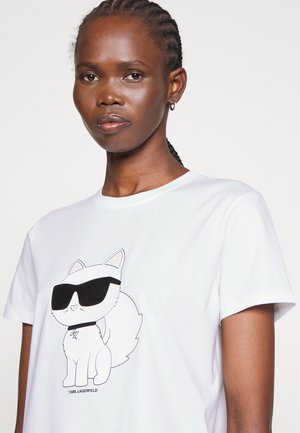 White cotton t-shirt with a black line-drawn cartoon cat wearing sunglasses. Simple, short sleeves, and crew neck design.