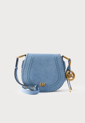 Light blue suede crossbody bag with stitched detailing, gold MK logo, adjustable strap, and gold MK charm on white background.