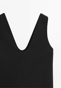 Black sleeveless garment with a deep V-neckline, displayed against a white background.
