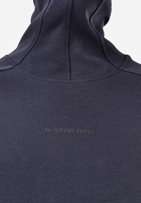 Felpa con cappuccio blu navy dal texture morbido, con colletto alto e il logo in rilievo "G-STAR RAW" sulla schiena.