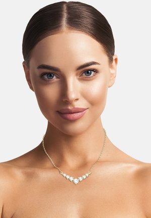 Goldkette mit einer zarten Kette, die fünf klare, tropfenförmige Kristalle in absteigender Anordnung zeigt.