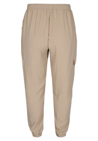 Béžové, lehké jogger kalhoty vyrobené z tkané látky. Mají elastický pas, boční kapsy a zúžené manžety na kotnících.