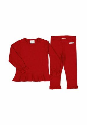 Röd långärmad topp med peplumkant och rynkade ärmslut, kombinerad med matchande leggings med rynkade fållar. Tillverkad av mjukt tyg.
