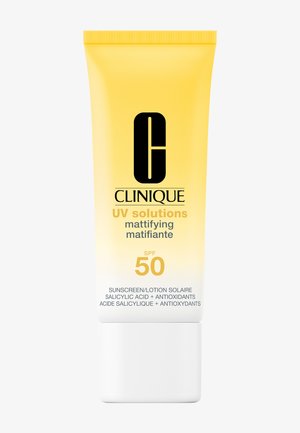 Écran solaire matifiant Clinique UV Solutions avec SPF 50 dans un tube souple jaune dégradé en blanc avec texte noir et doré.