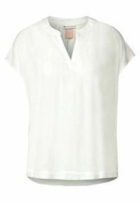 White short-sleeve blouse with a henley neckline and smooth texture. Features a loose fit and subtle hemline detailing.