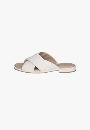 Sandalias planas blancas con tiras cruzadas, hechas de material liso. Cuentan con una suela plana y un diseño minimalista. Plantilla de color marrón claro.