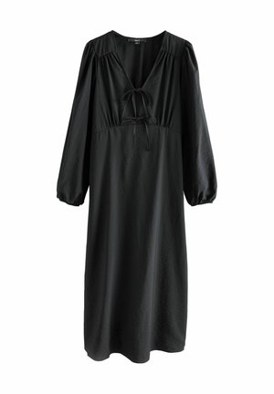 Vestido negro midi hecho de tela suave. Presenta un escote en V con detalle de lazo y mangas largas abullonadas. Dobladillo acampanado.