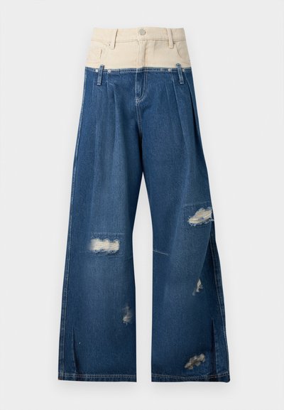 Jean taille haute à jambes larges avec ceinture beige, passants pour ceinture, zones usées sur les jambes et plis à l'avant.
