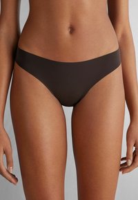 Brązowe bikini o minimalnym wzorze, wykonane z gładkiego, elastycznego materiału i z niskim stanem, zapewniające wygodę i smukły wygląd.