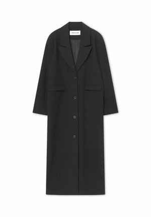 Must triibuline pikk mantel kraega, ees nööpidega ja kahe taskuga. Valmistatud tekstuurse kangaga, vormis lõike ja sirge lõikega.