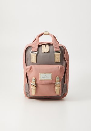 Plecak w kolorze różowym i szarym, wykonany z materiałów z regulowanymi paskami, mocnymi uchwytami, przednią kieszenią i metalowymi akcentami. Teksturowane wykończenie tkaniny.