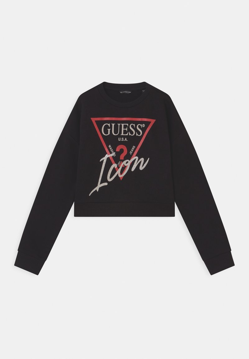 Sudadera negra recortada con mangas largas, con un logo triangular rojo y blanco que dice "GUESS U.S.A. Icon" con detalles en plateado.