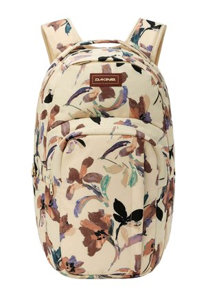 Mochila beige con estampado floral multicolor, correas de hombro acolchadas, bolsillo frontal con cremallera y etiqueta de la marca Dakine en la parte superior delantera.
