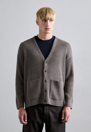 Gray ribbed cardigan with a V-neck, button front, and two front pockets. Made from soft fabric with a textured finish.