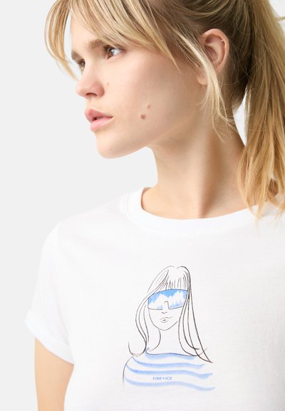 White cotton t-shirt featuring a graphic illustration of a woman with long hair and blue sunglasses, accompanied by horizontal blue stripes.