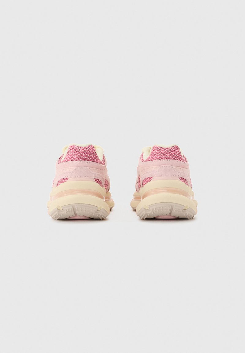 Pair of pink and beige athletic shoes shown from the back, featuring textured knit upper and thick cushioned sole on a plain background.