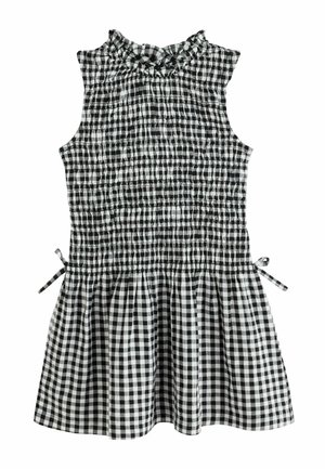 Ärmelloses schwarz-weiß kariertes Kleid mit gerafftem Ausschnitt, gerafftem Oberteil und Seitenschnürungen, dargestellt auf weißem Hintergrund.