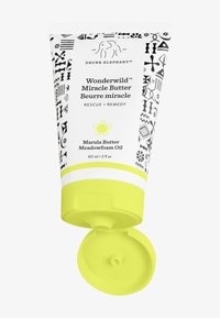 White tube with black geometric patterns, featuring a bright yellow cap. Label reads "Wonderwild™ Miracle Butter," highlighting key ingredients.