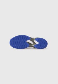 Sneaker sole with a blue rubber zigzag pattern, featuring a light grey midsole and white upper accents. Smooth texture overall.