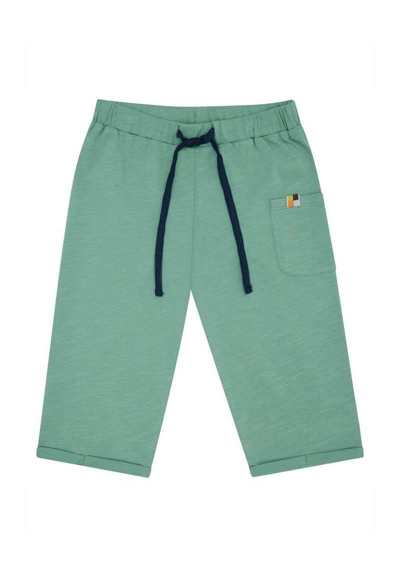 Helle grüne, verkürzte Jogginghosen aus weichem Stoff, mit einem dunkelblauen Kordelzug und einem kleinen, mehrfarbigen Patch auf der hinteren Tasche.