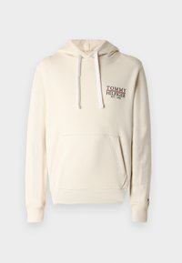 Κρεμ φούτερ με τσέπη μπροστά, κορδόνια και κεντημένο λογότυπο "TOMMY HILFIGER" σε μαύρο και κόκκινο. Μαλακό, υφασμάτινο ύφασμα με υφή.