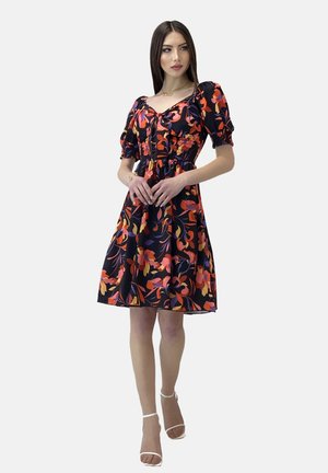 Black short dress with vibrant floral print in orange and purple, features puff sleeves, a cinched waist, and a flared skirt.