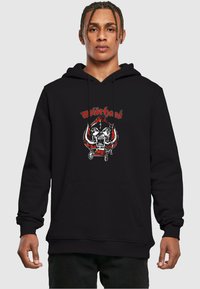 Black hoodie featuring a graphic print of a skull with horns and the text "Motörhead" in red and white, front kangaroo pocket, ribbed cuffs.