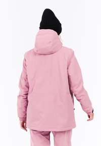 Roze waterdichte jas met een capuchon, elastische manchetten en een losse pasvorm, gemaakt van gladde stof. Beschikt over een minimalistisch ontwerp en neutrale kleur.