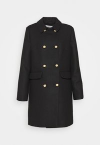 Abrigo negro de doble botonadura con cuello, tejido texturizado, botones en tono oro y dos bolsillos frontales. Corte clásico con silueta recta.