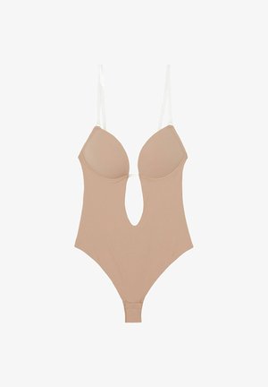 Body nude avec une découpe profonde à l'avant, en tissu doux, avec des bonnets moulés et des bretelles blanches ajustables. Il présente un design de jambe haute.