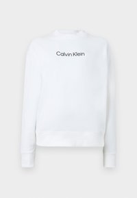 Sweat-shirt blanc à manches longues avec col, poignets et ourlet côtelés, avec le texte "Calvin Klein" en noir centré sur la poitrine.