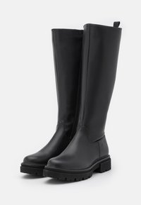 Black knee-high boots made of smooth leather with a round toe, side zipper, and textured rubber sole for traction.