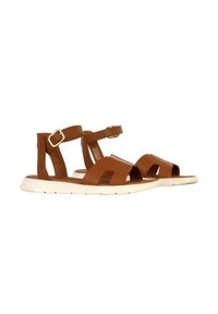 Sandales en cuir marron avec une bride de cheville, design à bout ouvert et semelle en caoutchouc blanc. Comprend des découpes géométriques et une boucle en métal.