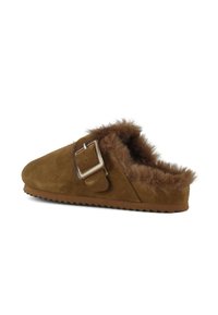 Brown suede slipper with a fuzzy fur lining and a side buckle. Features a rounded toe and textured rubber sole for grip.