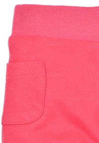 Heldere roze katoenen leggings met een flexibele tailleband en een klein zakje aan de zijkant, met een gladde textuur en zonder zichtbare patronen.