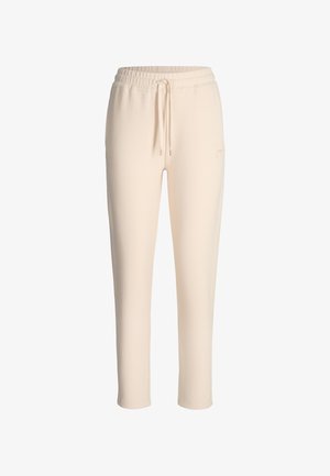 Beige Jogginghosen mit Kordelzugbund, glatter Textur, schlanker Passform und dezentem Branding am linken Bein.